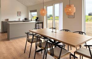 a kitchen and dining room with a wooden table and chairs at 4 Bedroom Cozy Home In Haderslev in Haderslev