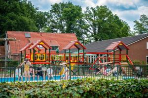 a playground with children playing in it at Recreatiepark Goorzicht in Aalten