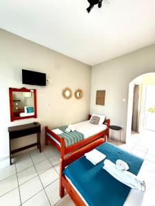 a hotel room with two beds and a mirror at Nikol Thea Studio in Kallithea Halkidikis