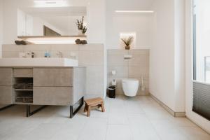 a bathroom with a sink and a tub and a toilet at FourElements Grand Chalet in Blankenburg +41 photos