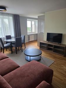 a living room with a couch and a table at Külaliskorter Aardla tn 120 in Tartu