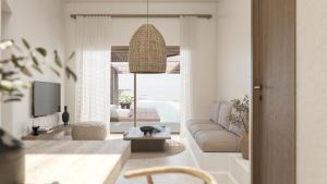a living room with a couch and a tv at Thalasses in Adelianos Kampos