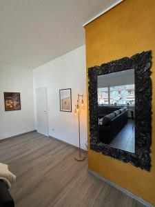 a living room with a mirror on a wall at Nice and cozy in Daaden in Daaden