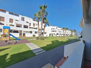 a playground in front of a apartment building at Apartamentos Alborada III in Vera