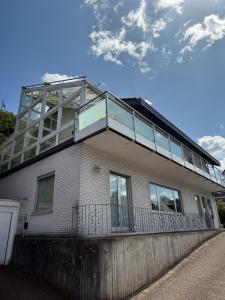 a house with a balcony on top of it at Nice and cozy in Daaden in Daaden