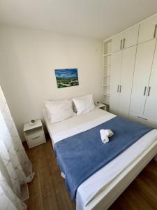a bedroom with a large bed and white cabinets at Kuća za odmor Nina in Čapljina +23 photos