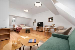 a living room with a couch and a bed at Apartmány Pod Jabloní in Jablonné nad Orlicí