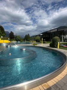 a large pool with blue water in a building at Ferienwohnungen Sonnrain 13 in Leogang