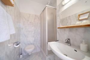 a white bathroom with a sink and a toilet at Mayrhof Zimmer, Bauernhofurlaub in San Pancrazio dʼUltimo +30 photos