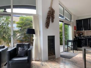 a living room with a chair and a fireplace at Bellevue Nr 123 - Lemmer in Lemmer