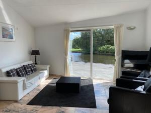 a living room with a couch and a table at Bellevue Nr 123 - Lemmer in Lemmer