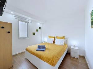 a white bedroom with a bed with a suitcase on it at Casa Vereda Ponta Delgada, S Miguel in Ponta Delgada +24 photos