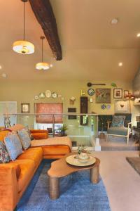 a living room with a couch and a table at Town Gate Cottage in Stainland