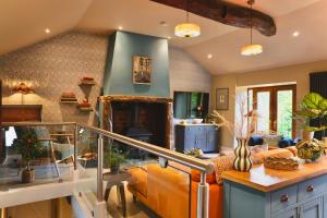 a living room with a couch and a table at Town Gate Cottage in Stainland +39 photos