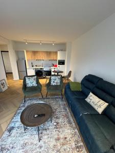 a living room with a couch and a table at Silhouette Suite at Nine Palms in Cape Town +9 photos