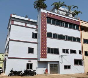 two motorcycles parked in front of a building at Dev'S Inn Luxurious Homestays in Similigurha