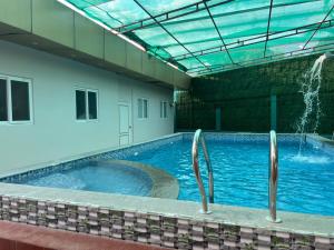 a large swimming pool in a building at Aerodon resort in Chennai