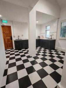 a black and white checkered floor in a kitchen at D'Monochrome in Singapore