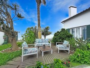 a patio with two chairs and a table at Casa Vereda Ponta Delgada, S Miguel in Ponta Delgada