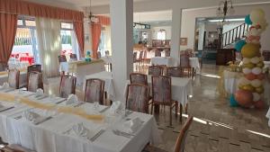a banquet room with white tables and chairs and balloons at Hotel Svizzero in Sangineto