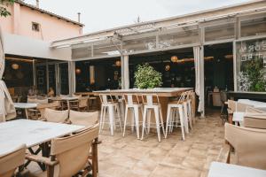 a patio with tables and chairs in a restaurant at GIARDINO High living suites in Drama