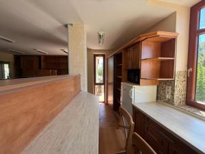a kitchen with wooden cabinets and a counter top at Balaton Vista in Balatonfüred