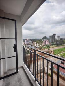 a balcony with a view of a city at Chic One Bedroom Apartment near The Kenya School of Government - KSG in Nairobi