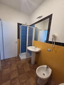 a bathroom with a sink and a toilet and a mirror at Ravello Sky & Sea in Ravello