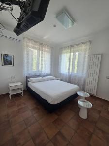 a bedroom with a large bed and windows at Ravello Sky & Sea in Ravello