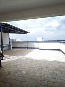 a person standing on the roof of a building at Chic One Bedroom Apartment near The Kenya School of Government - KSG in Nairobi