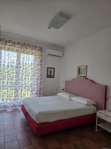 a bedroom with a large bed and a window at Ravello Sky & Sea in Ravello