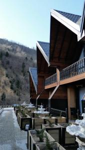 a building with tables and chairs in front of it at Aquarium BUNGALOW UZUNGÖL in Uzungöl