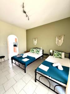 a bedroom with two beds and a room with at Nikol Thea Studio in Kallithea Halkidikis