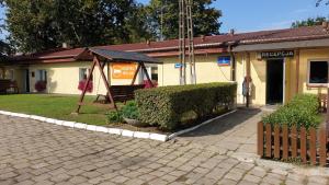 a building with a bench in front of it at Hostel Relax in Warsaw