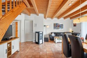 a living room with a couch and a tv at Waterkieker in Greetsiel