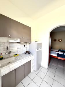 a kitchen with a sink and a refrigerator at Nikol Thea Studio in Kallithea Halkidikis