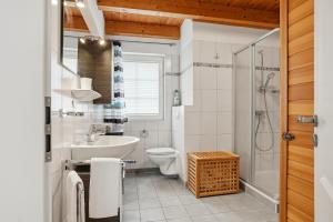 a bathroom with a sink toilet and a shower at Waterkieker in Greetsiel +33 photos