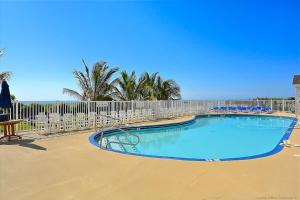 a swimming pool with chairs and a fence at Carousel 1905 in Ocean City