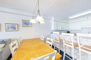 a dining room and kitchen with a wooden table and chairs at Carousel 1905 in Ocean City