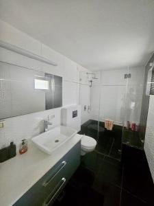a bathroom with a sink and a toilet and a shower at Kosher Villa in earth of Moshava in Jerusalem +33 photos