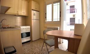 a kitchen with a table and a stove and a table and chairs at Amelie in Loutraki +8 photos