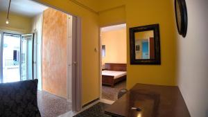 a room with a room with a bed and a mirror at Amelie in Loutraki