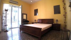 a bedroom with a large bed and a large window at Amelie in Loutraki