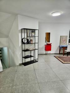 a room with a clock on a shelf on a wall at Kosher Villa in earth of Moshava in Jerusalem