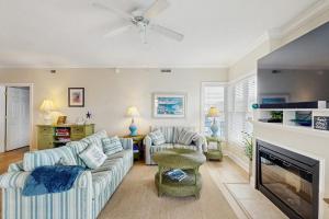 a living room with two couches and a fireplace at Condo 4100 #201 in Ocean City