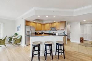a kitchen with a counter and bar stools at Condo 4100 #201 in Ocean City