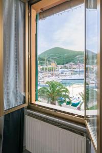 a window in a room with a view of a harbor at Albergo NARDINI in Le Grazie