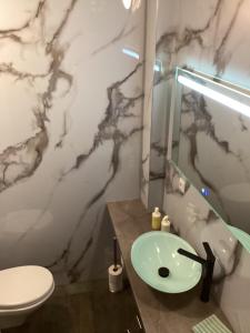 a bathroom with a sink and a toilet at B&B DownUnder in Vlissingen +39 photos