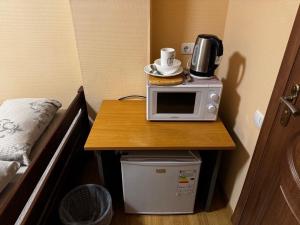 a microwave on a table in a room at Old Town - Andrew descent in Kyiv