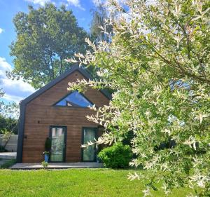 a house with a tree in front of it at Eleonor Accommodation exclusive house in Liszki